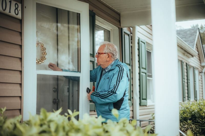 Battery-powered smart video doorbell on a door frame
