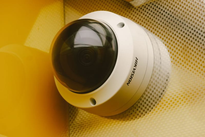 Compact plug-in indoor security camera on a shelf