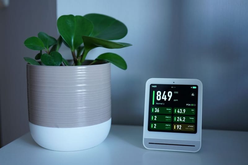 Portable CO2 monitor on a home office desk